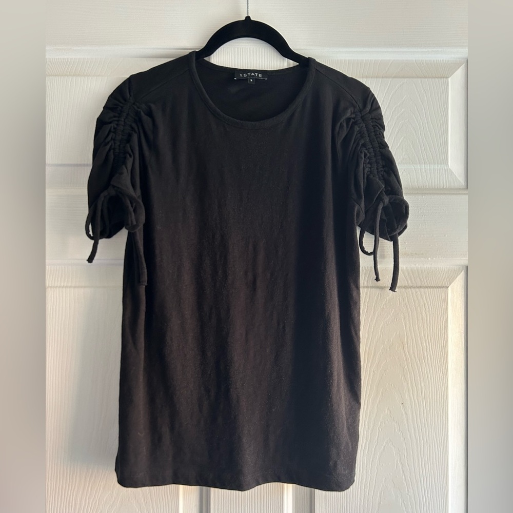 State black top featuring ruched sleeves with adjustable ties